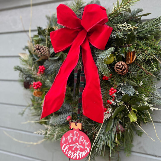 Christmas wreath with a red bow and 'Merry Christmas' tag.