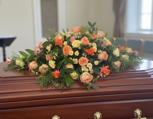 A customer specified they wanted a spray for a coffin made with roses in peach and orange colours.
