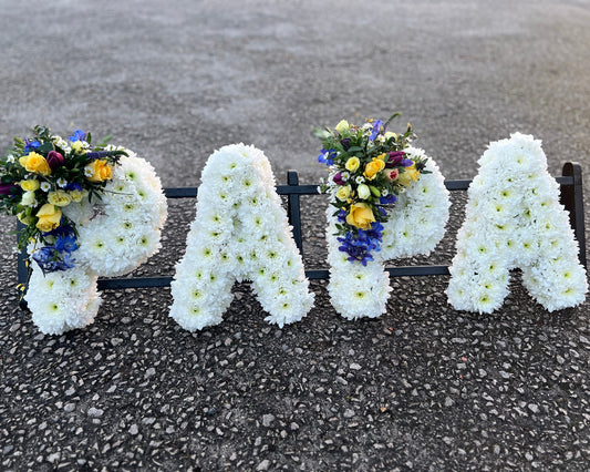 The word PAPA created in carefully massed Chrysanthemum flowers with sprays of mixed seasonal flowers,