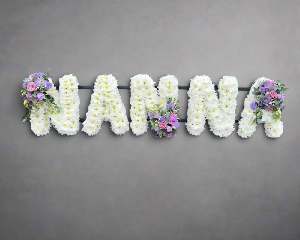 The word NANNA created in massed Chrysanthemum flowers with pretty lilac sprays.