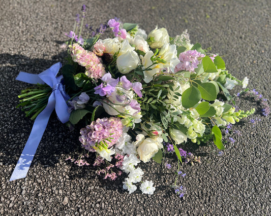 A beautiful tied sheaf in a cottage garden style. Filled with Summer favourites like Sweetpeas, Roses, and Hydrangea.