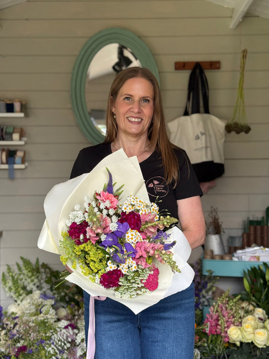 Alison holding a gift bouquet ready to post.