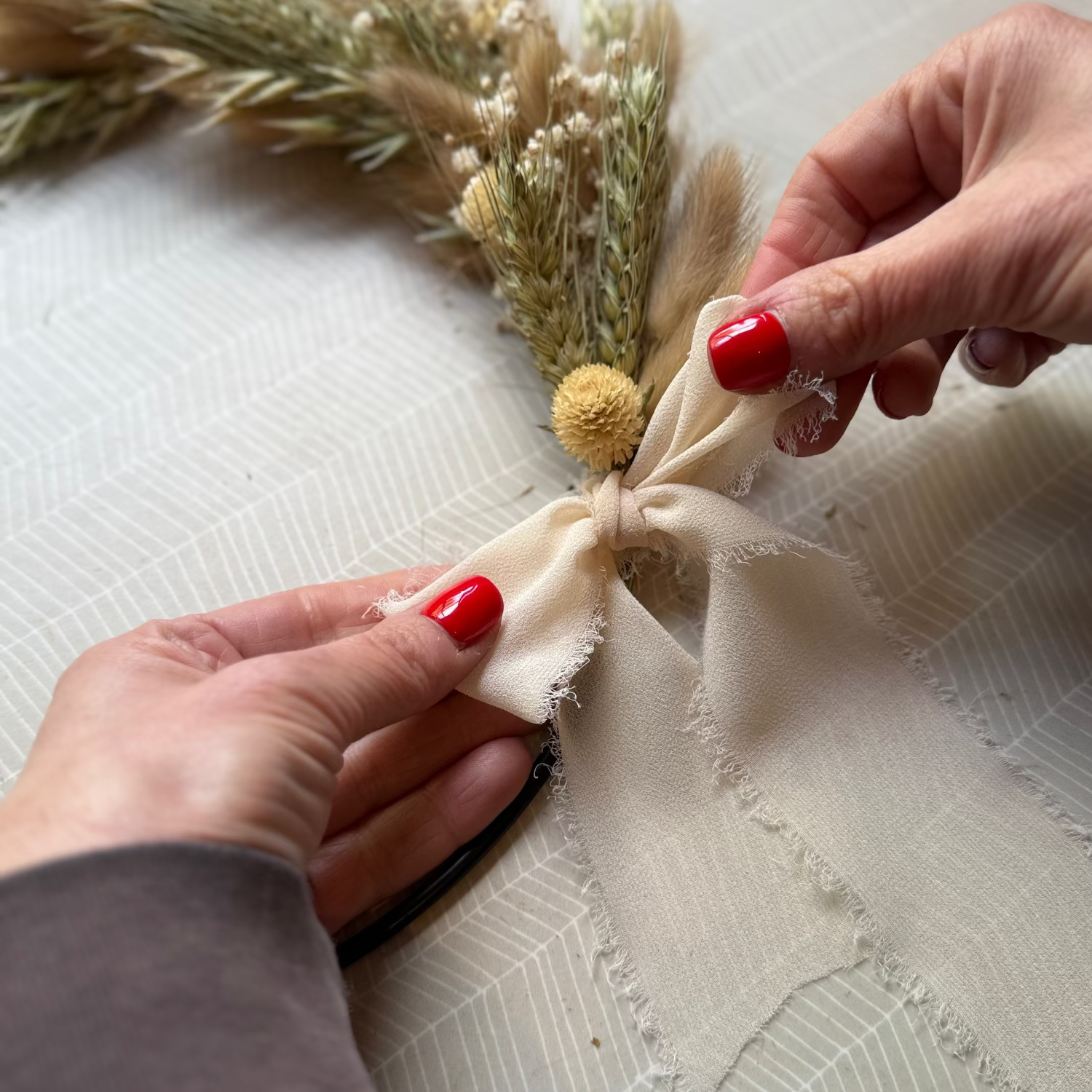 Person arranging dried flowers 