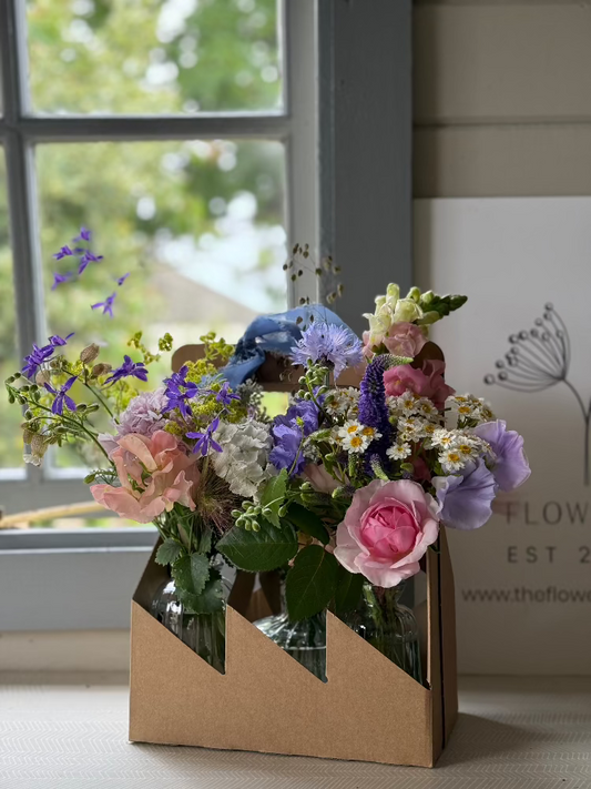 A collection of 3 bud vases brimming with homegrown flowers in their carrier ready for local delivery by Flower Farm Floristry, Burscough, Ormskirk, Lancashire. Picture by Millie Rose Content