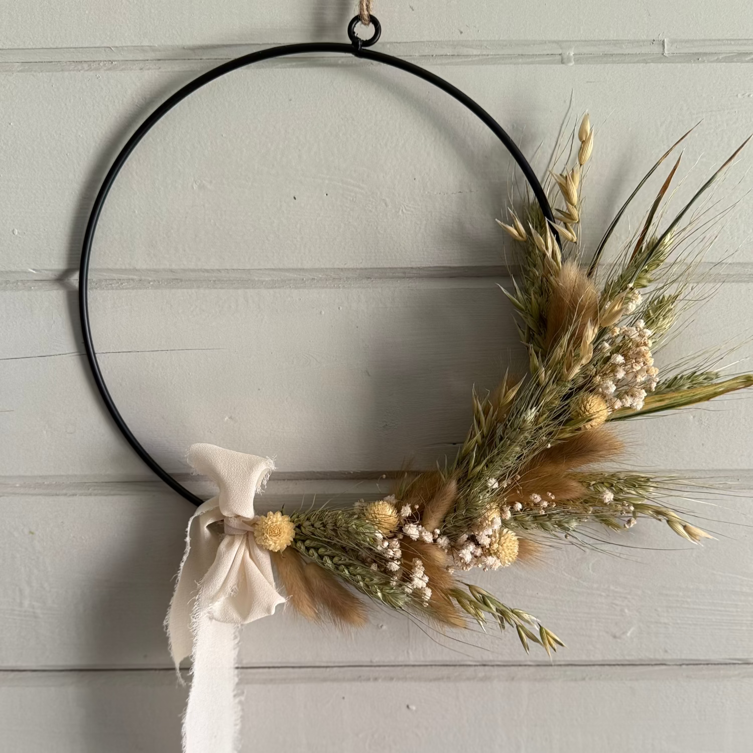 Decorative dried flower wreath with dried grasses and a bow