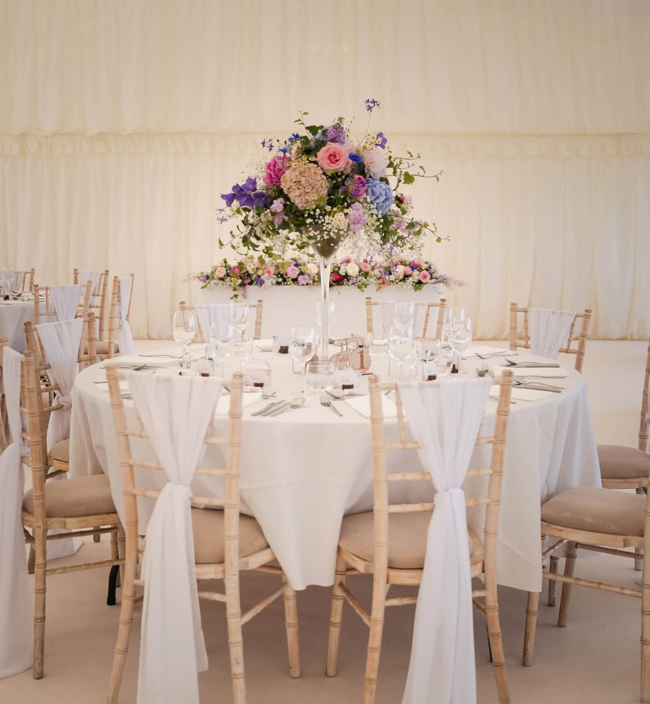 Photo by @mop_photos of the table flowers created by Flower Farm Floristry in June 2025 for a farm wedding in a marquee in Halsall.