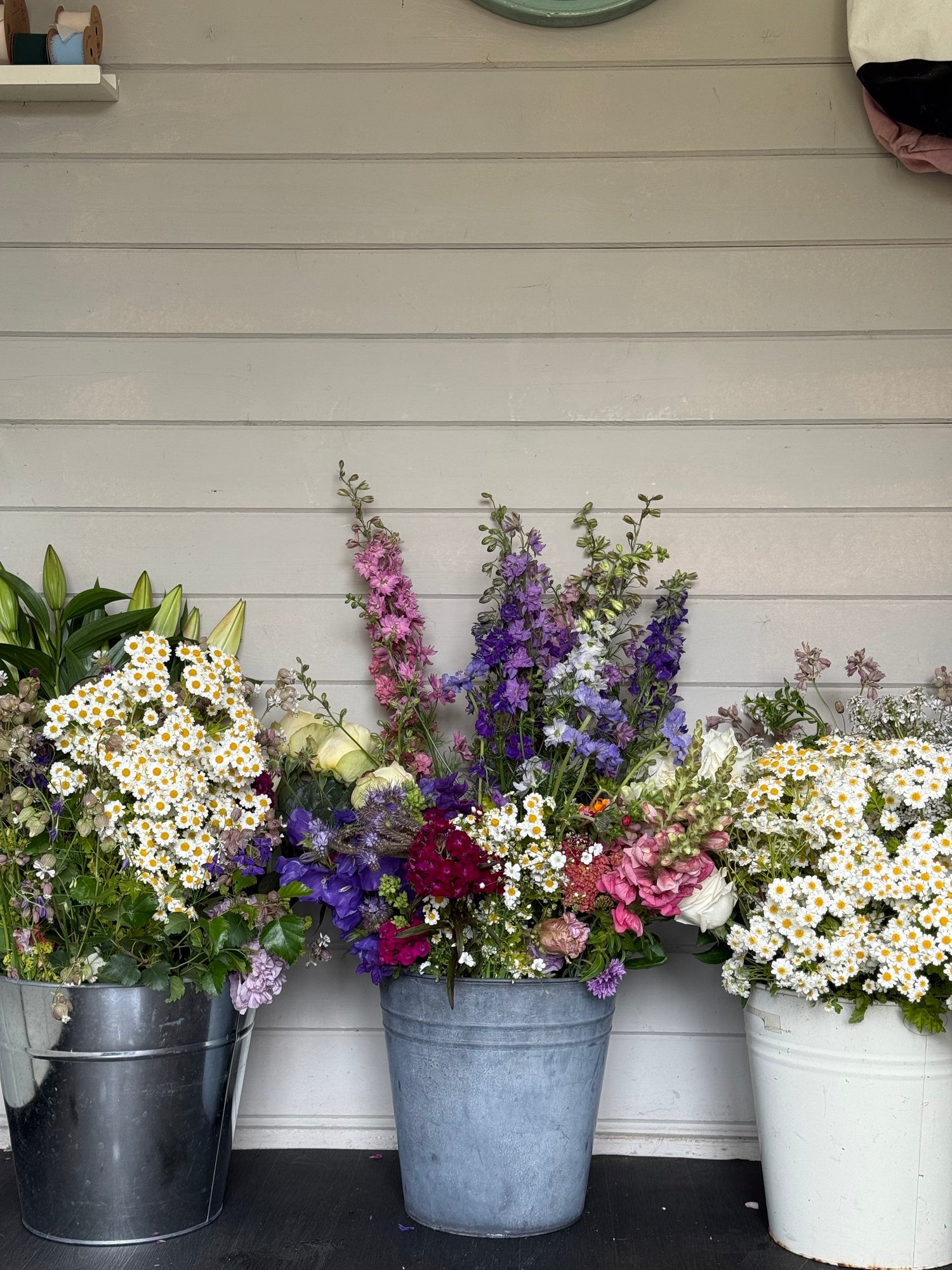a trio of buckets full of beautiful homegrown flowers in flower farm floristry workshop in Burscough, Ormskirk, Lancashire picture by Millie Rose Content