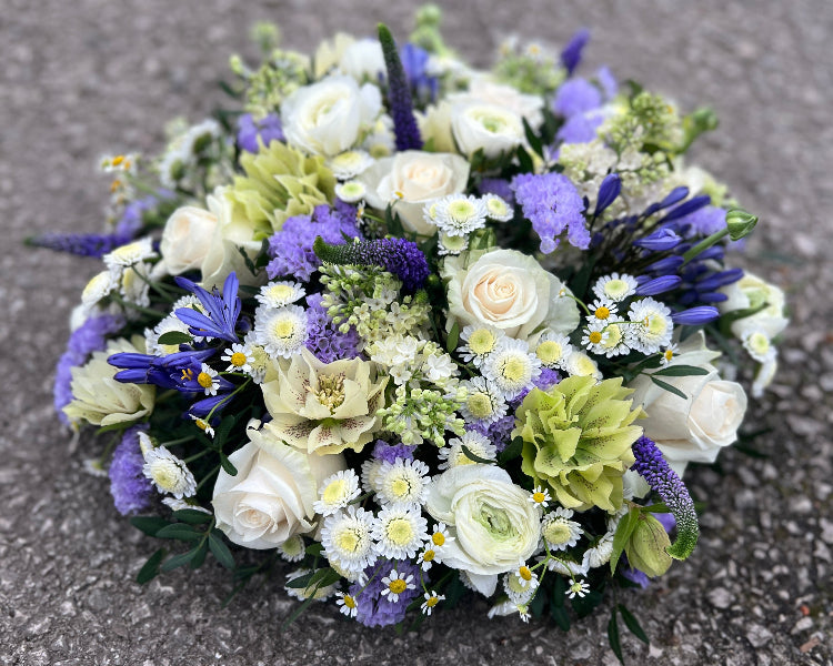 A beautiful posy tribute made using the nicest seasonal flowers.