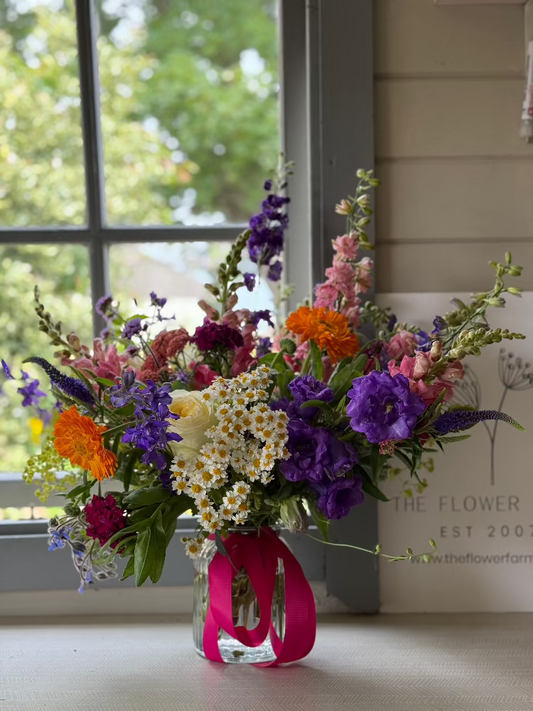 A stunning bouquet using homegrown flowers by Flower Farm Floristry, presented in a glass vase with a bow. Lancashire florist, Burscough, Ormskirk. PIcture by Millie Rose Content