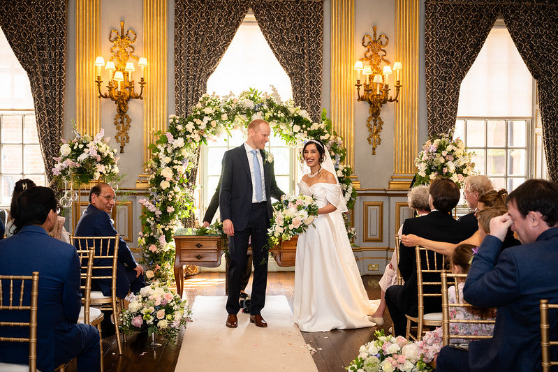 Wedding florals in pale pink and white flowers, includes aisle flowers, pedestals, moon arch and bouquet.