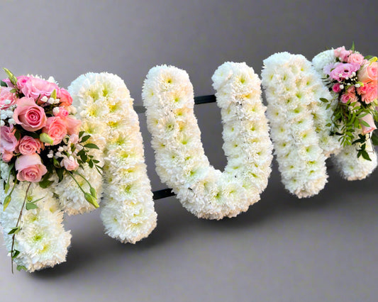 MUM letters of white Chrysanthemums with pink sprays.