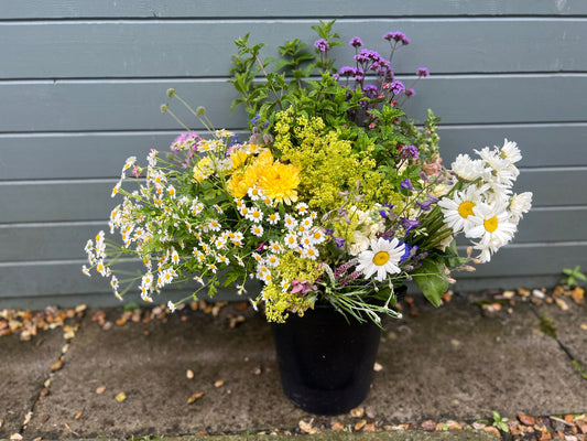 a bucket full of flowers and foliage ready to arrange as you wish for your wedding or other special event.