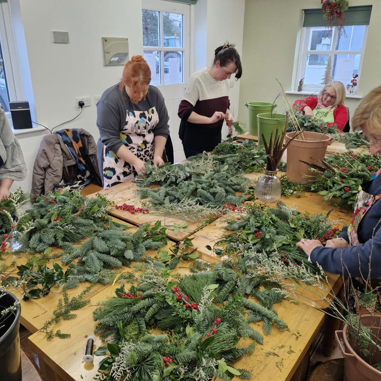 People making Christmas wreaths