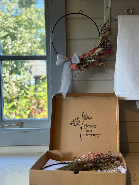 kit  of dried flowers to make a wreath, with 'Flower Farm Floristry' branding, finished wreath in the background.