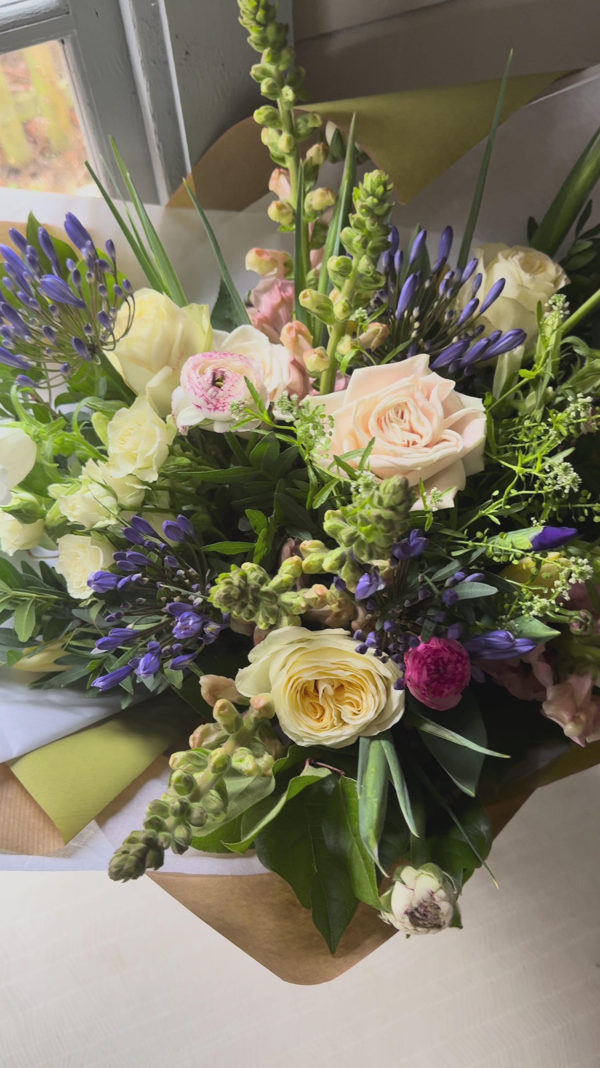 A video showing all angles of a fresh flower bouquet in a glass vase